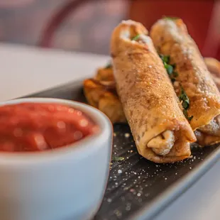 a plate of food with dipping sauce