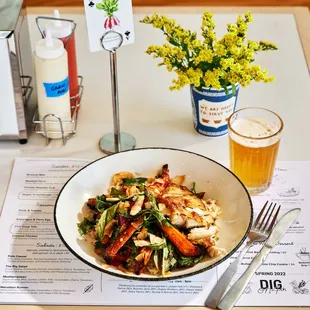 a plate of food and a glass of beer