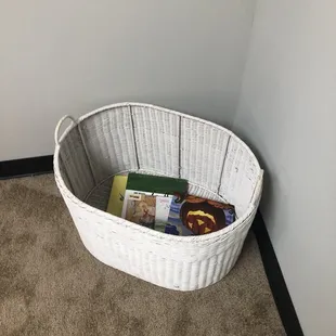 Books in nursing room for older siblings while mom feeds the baby