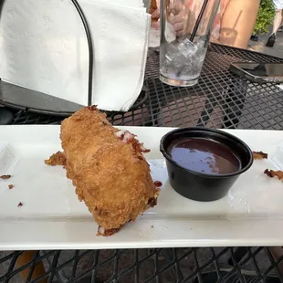 a fried chicken sandwich with dipping sauce