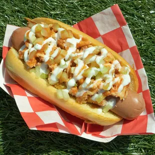 a hot dog covered in toppings