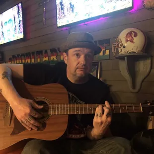 My friend playing guitar while we hang out.