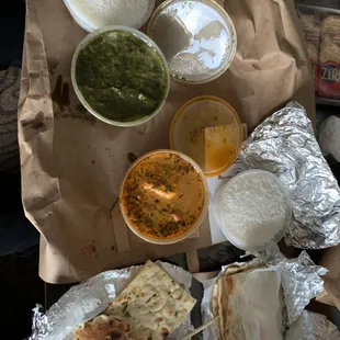 saad paneer on top, saag tikka masala in middle, and garlic naan on bottom