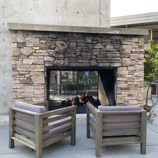 two chairs in front of a fireplace