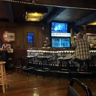 a man and a woman sitting at a bar