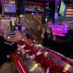 a man and woman sitting at the bar