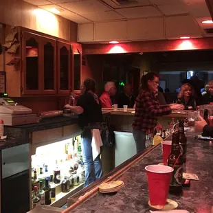 a group of people sitting at a bar