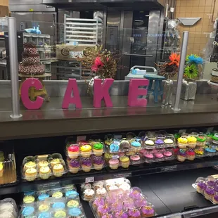 a display of cupcakes in a bakery