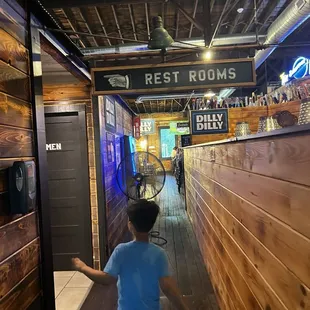 Bathroom sign and 21+ bar entry just past the (DILLY DILLY) sign