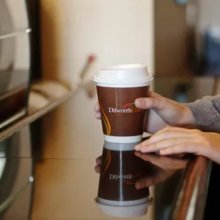a woman holding a cup of coffee