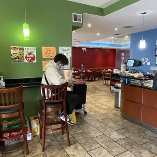 a man sitting at a table in a restaurant