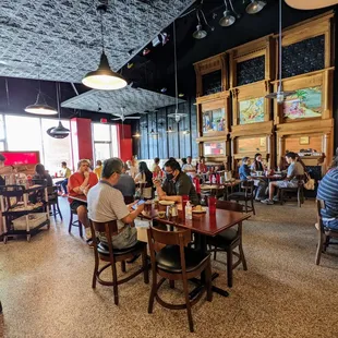 Inside. Dining room. View from back table facing front of house. Most of the seating space is captured in this photo.