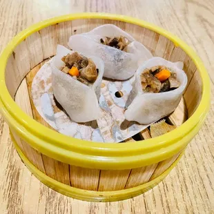 a bowl of steamed dumplings