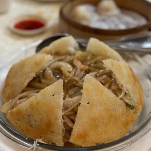 Crispy rice noodles with pickled vegetables and shredded pork.