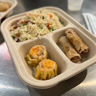 a tray of food with rice and vegetables