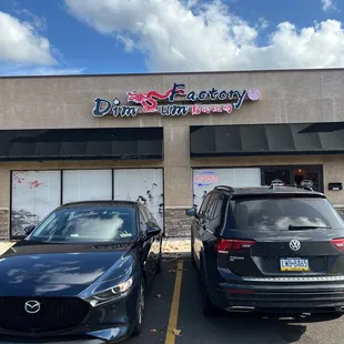 two cars parked in front of the store