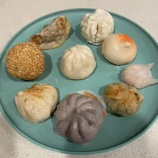 Clockwise from Sesame Seed Ball: Pork Fried Dumpling, Bbq pork bun, peach bun, Steamed Shrimp Dumpling, Shrimp Chinese Chives, taro bun