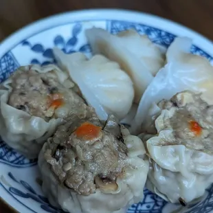dumplings in a blue and white plate