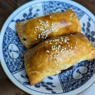 two pastries on a blue and white plate