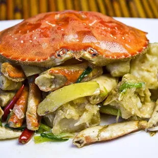 a crab and vegetables on a white plate