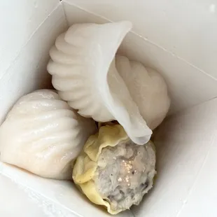 three dumplings in a white box