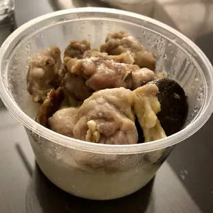 Steam chicken black mushroom over rice. It also has a piece of lap cheong (Chinese sausage). The chicken has bones in it.