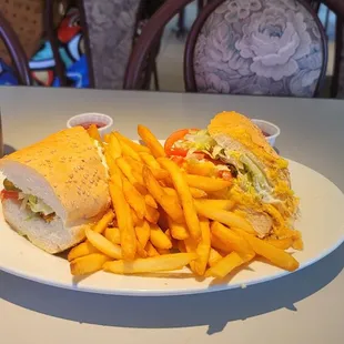 Grilled Chicken Po'Boy on French bread with French fries.