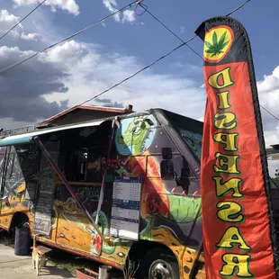 a colorful food truck parked on the side of the road