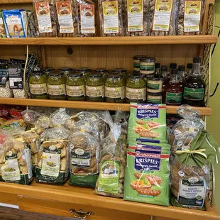 a display of olives, bread, and condiments