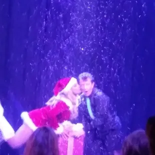 a man in a suit and a woman in a santa claus outfit