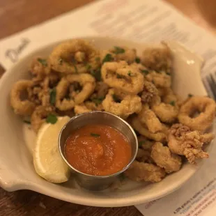 a plate of calamails and sauce