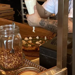 a man making a pizza