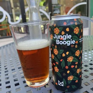 a can of jungle boogie next to a glass of beer