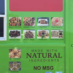 a green food truck with stickers on it