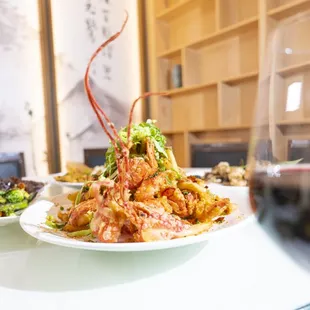 a plate of food and a glass of wine