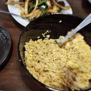 a bowl of rice with chopsticks