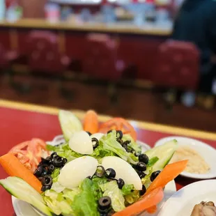 a plate of salad and chicken
