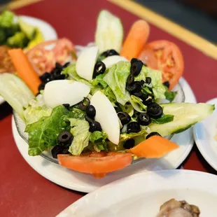 a plate of salad with meat and vegetables