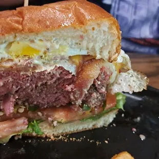 ASK FOR THE DASH BURGER- patty mid rare w corned beef Swiss cheese jalapenos horseradish mayo over easy egg lettuce tomatoes and bacon.
