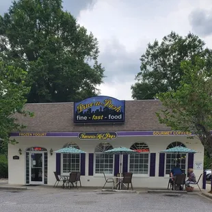 Front of restaurant with tables/umbrellas