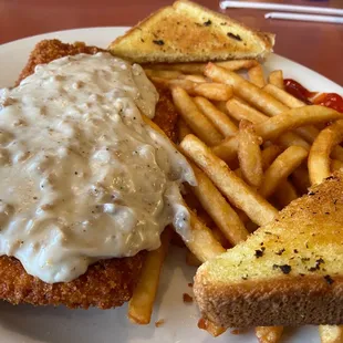 Country Fried chicken topped with sausage gravy, fries &amp; garlic toast