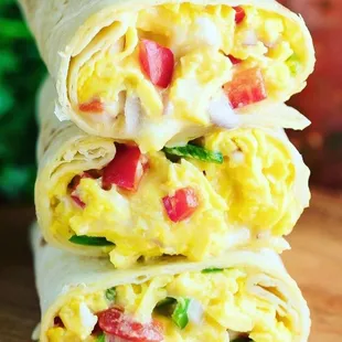 a stack of breakfast burritos