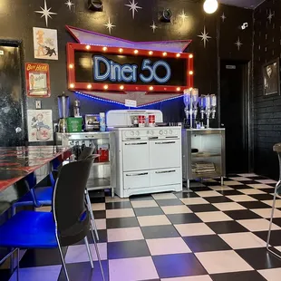 a checkered floor with a neon sign