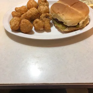 a sandwich and tater tots on a plate