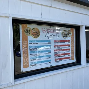 a menu in a window of a restaurant