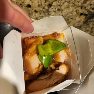 a hand holding a piece of food