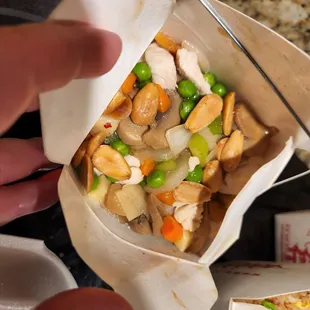 a person cutting a piece of pizza