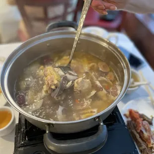 Fresh coconut (half) chicken hot pot - signature dish and worth the $46 price tag! + $1.50 side house-made sauce (not pictured)