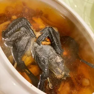 a bowl of soup with fish in it