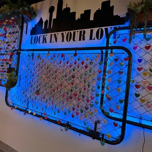 a chain link fence with hearts on it